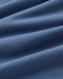 Detailed view of blue fabric intended for shorts, highlighting its weave and hue.
