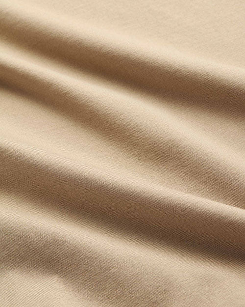 Close-up of a taupe-colored fabric, showcasing its soft texture and neutral tone.