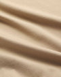 Close-up of a taupe-colored fabric, showcasing its soft texture and neutral tone.