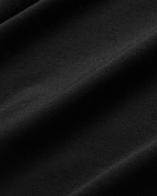 Close-up of a textured black fabric, showcasing its rich color and intricate weave details