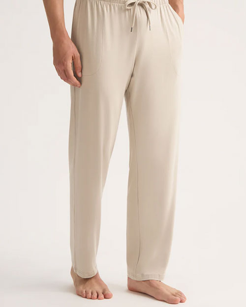 A man in beige pants is depicted, emphasizing a simple and modern style choice.