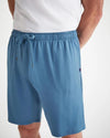 Up-close in picture of blue lounge shorts with a drawstring.  The image shows the details of the deep pockets on the front of the shorts.