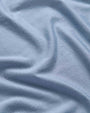 A blue fabric showcasing a soft and textured appearance.
