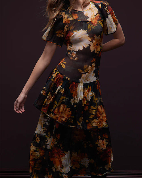 Woman wearing a floral dress with a dark background