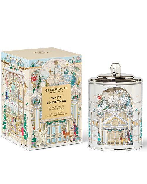 Decorative candle and packaging with festive design on a white background