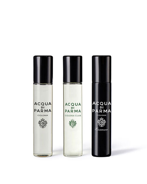 Three elegant perfume bottles arranged on a white surface, showcasing their unique shapes and colors.