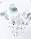 Up-close of the white t-shirt to show the small stones in the shape of a bear with a bow accent.