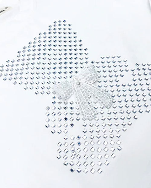 Up-close of the white t-shirt to show the small stones in the shape of a bear with a bow accent.