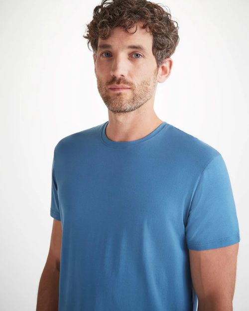 Gentleman wearing a blue shirt.  This image only shows the top of the man.