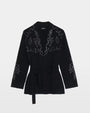 Black sweater with silver embellishments on a white background. 