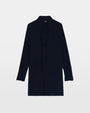 An image of a navy dress with a center ruffle on a white background. 