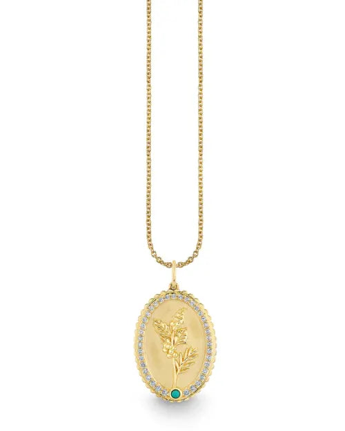 Image of a medallion necklace, showcasing an engraved flower design and diamond border. 