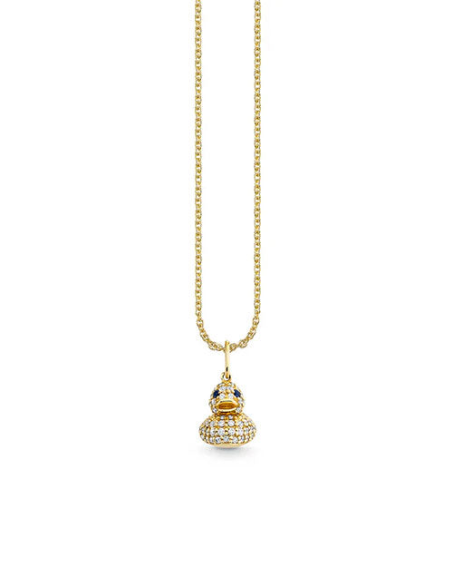 A gold chain necklace featuring a duck-shaped pendant adorned with small sparkling stones. The duck’s eyes are highlighted with darker stones, adding detail to its jeweled and playful design.