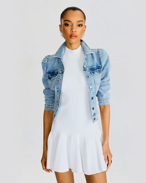 Model wearing a white dress and a blue denim jacket, legs are not shown in this picture.