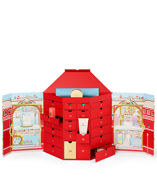 Red advent calendar with open doors revealing festive scenes on a white background