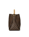 Side view  of an elegant Louis Vuitton handbag featuring the classic brown LV monogram canvas. The bag boasts a trapezoidal shape, complemented by tan leather trim and handles, and is adorned with gold-tone hardware.