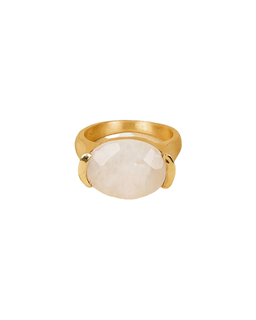 A gold ring featuring a large, oval-shaped white gemstone set in the center, secured by two prongs on either side.