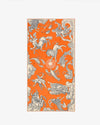 An orange and beige scarf with flowing patterns of various animals and mythical creatures. 
