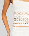 Close up of a white crochet dress, some areas are see through.