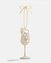 Gold wine glass ornament with pearls on a white background