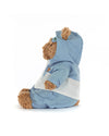Side view of a plush teddy bear wearing a light blue and white hooded outfit, sitting upright and facing left, with soft fabric clothing covering most of its body.