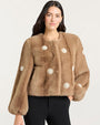 Front view of a light brown faux fur jacket featuring a round neckline, long sleeves, and decorative pearl-like embellishments arranged in circular patterns across the front and sleeves.