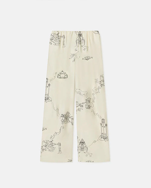 Long off-white pajama pants. The pants have black line drawings of various whimsical characters and scenes such as warriors on horses and towers. The background is plain white.