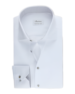 A  white dress shirt with a spread collar, grey buttoned front, and long sleeves featuring rounded cuffs. 