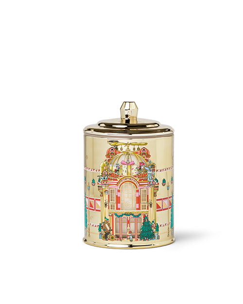 Decorative gold candle with a festive design on a white background