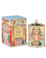 Decorative candle and packaging with festive design on a white background