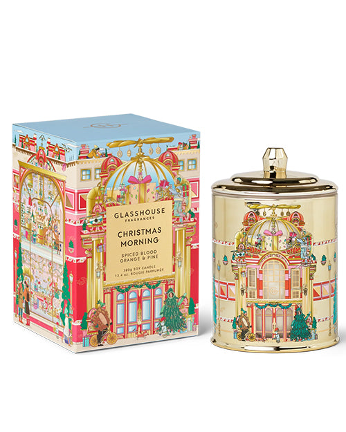 Decorative candle and packaging with festive design on a white background