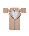 A a garment bag in beige color with brown piping. The bag is laid flat and open, revealing a white dress shirt neatly placed on a hanger inside. The garment bag has two beige flaps folded outward, resembling wings. The main compartment is unzipped, allowing a clear view of the shirt.