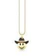 Gold necklace with a pendant shaped like a yellow smiley face wearing a black cowboy hat adorned with small sparkling stones, hanging from a delicate gold chain.
