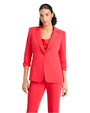 Front view of a person in a bright red suit with a matching top, standing against a plain white background.