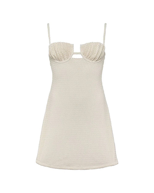 A white, crocheted dress with thin straps. The bodice is fitted and showcases a delicate, tight-knit crochet pattern, while the cut-out detail just below the bust is bordered by a slightly thicker, more open crochet weave, creating a subtle contrast. The skirt portion of the dress continues with a mix of tight and loose crochet patterns. 