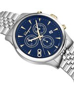 Close up of aSalvatore Ferragamo dial with blue dial  with gold accents and silver metal strap on a white background