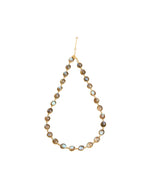 A necklace featuring evenly spaced round, iridescent stones set in gold-colored metal, connected by small links to form a complete loop. A lobster clasp closure is visible in the image.
