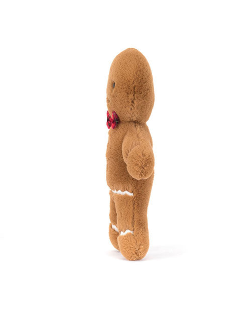 Side view of a brown gingerbread man plush toy with white icing-like stitching, a red plaid bow tie, and soft fabric texture, standing upright.