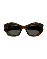 Front view of sunglasses with a tortoiseshell pattern frame and dark tinted lenses.