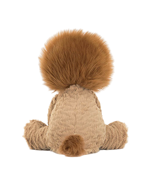 Back view of a plush toy lion with a large, fluffy dark brown mane and small tail. The light brown body has textured fabric, and the toy is seated with legs spread to the sides.