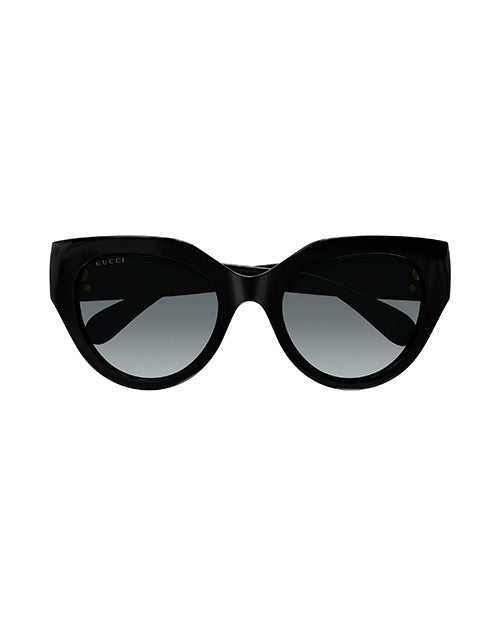 Front view of black narrow cat-eye sunglasses with dark grey lenses.
