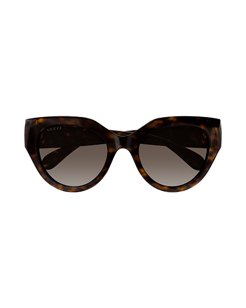 Front view of tortoiseshell colored, narrow cat-eye sunglasses with brown lenses.