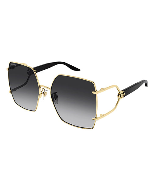 Rectangular oversized Gucci sunglasses. The temples are black, and the large lenses appear to be a gradient black with GG logo and gold rim. The brand name ‘Gucci’ is visible on the top corner of the right lens.