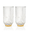 Two tall, clear glass tumblers with textured, vertical grooves. They have a curved design and golden bases, conveying elegance and sophistication.