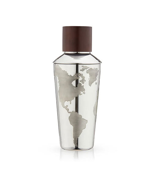 A silver cocktail shaker with a map of the world etched on its surface. It features a dark brown cap and stands against a white background.