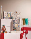 Gift set with decorative boxes and a bear figurine on a beige background