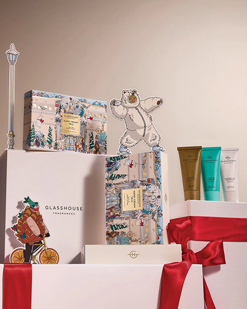 Gift set with decorative boxes and a bear figurine on a beige background