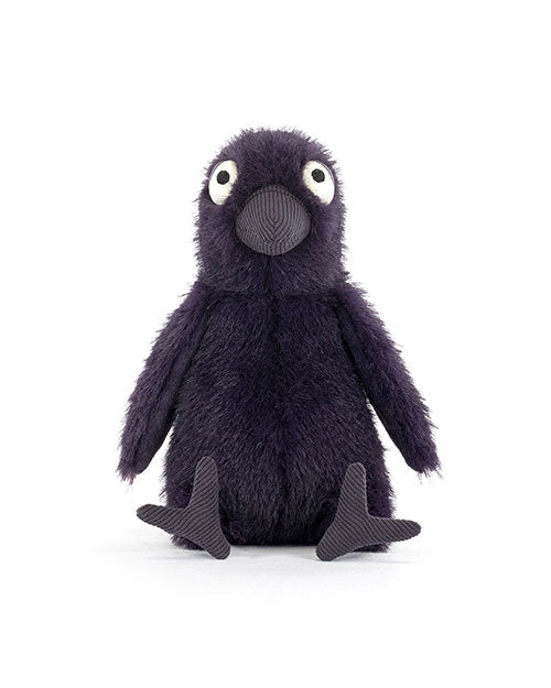 Plush toy bird with dark purple fur, large white and black eyes, a textured beak, and contrasting material feet, sitting upright with legs stretched forward.