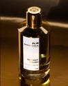 Mancera Instant Crush perfume bottle on a reflective surface with a dark background