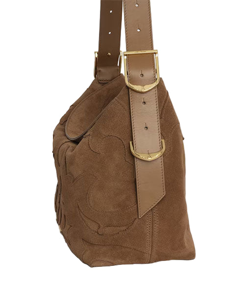 Side view of a brown suede handbag with a leather strap featuring multiple adjustment holes and gold-colored buckles. The side of the bag displays an embossed design.